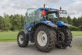 Modern blue tractor on a farmyard