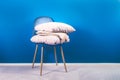 Modern Blue Velour Chair with Beige Cushions and Throw