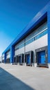 A stunning image of modern industrial warehouse exterior under clear blue sky. Large loading bays visible. Royalty Free Stock Photo