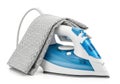 Modern blue and white steam iron with fabric isolated on white background Royalty Free Stock Photo