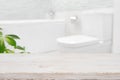 Modern blurred bathroom background with wooden table top in front Royalty Free Stock Photo