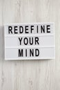 Modern board with text `Redefine your mind` over white wooden background, top view. Overhead, flat lay Royalty Free Stock Photo