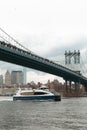 modern boat under Manhattan bridge near Royalty Free Stock Photo