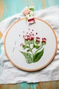 Hoop modern embroidery with botanical motifs on a wooden background Royalty Free Stock Photo