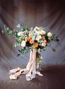 Modern bouquet in peach and beige tones on dark grey background. Flower invitation card. Elegant wedding inspiration