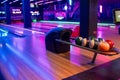 Modern bowling alley with ball rack and neon lights Royalty Free Stock Photo