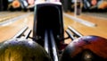 Modern bowling room with a green ball rolling from a mechanism in front of the bowling alley. Media. Close up for the Royalty Free Stock Photo