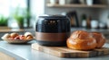 Modern bread maker baking fresh loaves on a kitchen countertop Royalty Free Stock Photo