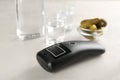 Modern breathalyzer and vodka on white table Royalty Free Stock Photo