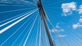 Modern bridge pylon against a blue sky. Detail of a multi-span cable-stayed bridge. White cable-stayed suspension bridge Royalty Free Stock Photo