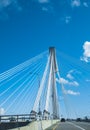 Modern bridge pylon against a blue sky. Detail of a multi-span cable-stayed bridge. White cable-stayed suspension bridge Royalty Free Stock Photo