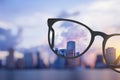 Modern bright city view through eyeglasses Royalty Free Stock Photo