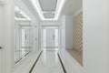 Sleek White Corridor: Stylish Mirror and Wardrobe with Elegant White Doors