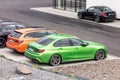 The modern bright green BMW M340i saloon vehicle and other BMWs at the dealership ready for test drive