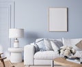 Modern bright living room in costal style, white sofa and wooden furniture on light blue wall background