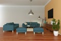 Modern bright skandinavian interior design with blue sofas and orange wall Royalty Free Stock Photo