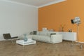 Modern bright skandinavian interior design with white sofa and orange wall Royalty Free Stock Photo