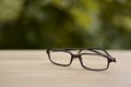 Brown modern glasses frame with blurry tree background Royalty Free Stock Photo