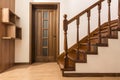 Modern brown oak wooden stairs and doors in new renovated house