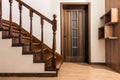 Modern brown oak wooden stairs and doors in new renovated house