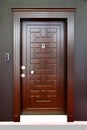 Modern brown wooden looking steel door, electronic security lock system Royalty Free Stock Photo