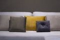 Modern brown, yellow and gray fabric flannel pillows on gray fabric cushion sofa interior Royalty Free Stock Photo