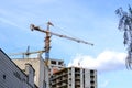 Modern building activity. Tall tower crane at a construction site when building a house Royalty Free Stock Photo