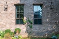 Modern building brick wall with window and green natural exterior for beautiful architecture home and living retro styel Royalty Free Stock Photo