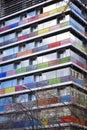 Modern building with colored and numbered glass balconies.