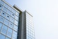 Modern building, exterior. High-rise business center made of glass, background of clear sky during the day. Royalty Free Stock Photo