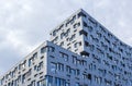 Modern building facade with irregular form of windows. Royalty Free Stock Photo