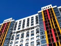 Modern building facade with windows, balconies and boxes for air conditioner on blue sky background Royalty Free Stock Photo