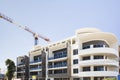 Modern building finishing with a crane under blue sky Royalty Free Stock Photo