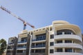 Modern building finishing with a crane under blue sky Royalty Free Stock Photo