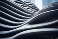 Modern building with futuristic design, abstract curve shapes on sky background. Low angle of high-rise tower, wavy geometric Royalty Free Stock Photo