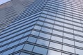 Modern building glass walls with sky and cloud reflection. Blue business background Royalty Free Stock Photo