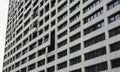 modern building with grid-like facade rectangular windows and central open window, viewed from low angle. Royalty Free Stock Photo