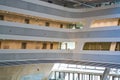 Modern building inside. With slanted and semicircular walls, big windows and balconies, with illumination. Architecture. Geometry.