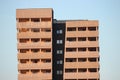 Modern building for living or office. perforated plates are used in finishing. Asymmetric, with Windows and balconies on different