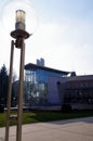 Urban square with modern and former architecture and modern street lamp as a foreground Royalty Free Stock Photo