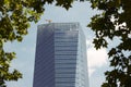 Modern building metallic and glass facade detail with tree limb Royalty Free Stock Photo