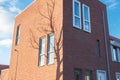 Modern building with shadow of a tree on the brick wall