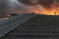 Modern building stairs on the downtown of Lisbon. With flashy sunset and silhouette of woman on top. Portugal. Lisbon