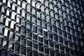 modern building, featuring over 100 gleaming glass windows against a blue reflective background Royalty Free Stock Photo