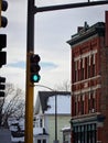 Modern building stands beside a vibrant green streetlight