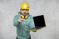 Modern building supervisor keeps the computer in his hands, technology at work Royalty Free Stock Photo