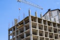 Modern building under construction against blue sky. Tower crane Royalty Free Stock Photo