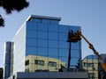 Modern Building Window Washing From Elevated Cherry Picker Lift