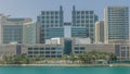 Modern buildings in Abu Dhabi skyline timelapse with mall and beach. Royalty Free Stock Photo