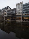 Modern buildings architecture reflection in Bleichenfleet Alster river canal in city centre of Hamburg Germany